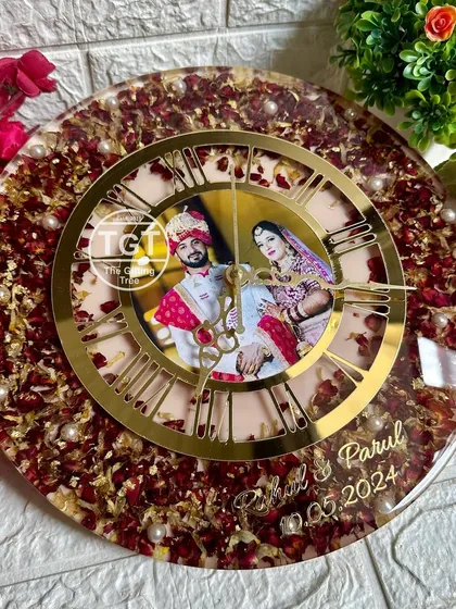 This shot highlights the beautiful contrast between the red rose petals, the golden clock dial, and the couple's wedding attire in the central photo.