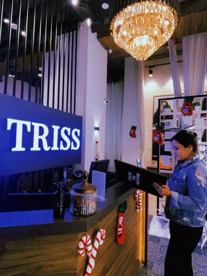 A client looking at our service menu at the festively decorated reception. This post highlights a special offer on hair color services, available for a limited time.