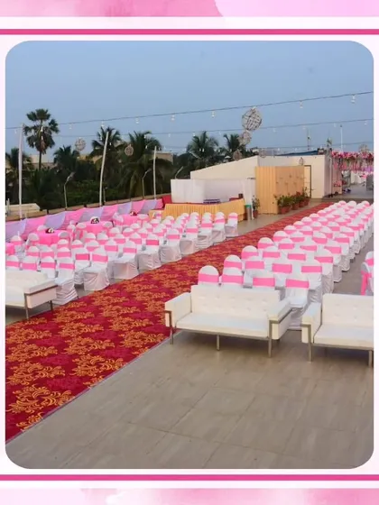 Guest seating for a large outdoor wedding, with pink sashes on the chairs to match the overall theme. The red patterned aisle runner adds a touch of traditional contrast.