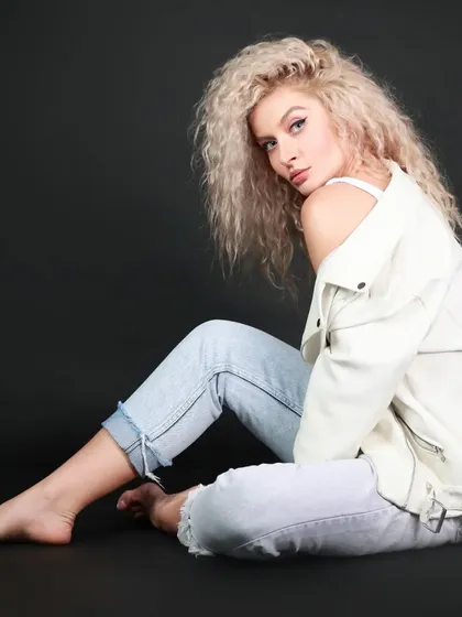 A seated floor pose from the same series, creating a relaxed yet elegant look.