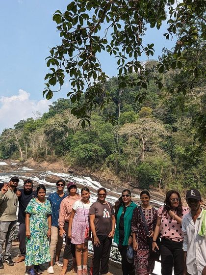 Our group at a waterfall in Kerala, a refreshing stop during our coastal exploration.