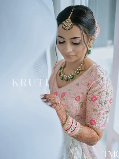 A delicate and detailed close-up of the bride-to-be. This shot focuses on her serene expression and the beautiful details of her makeup and jewelry, capturing a moment of quiet reflection.