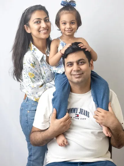 A classic family pose with the daughter on her father's shoulders. This is always a favorite for capturing joyful family moments.