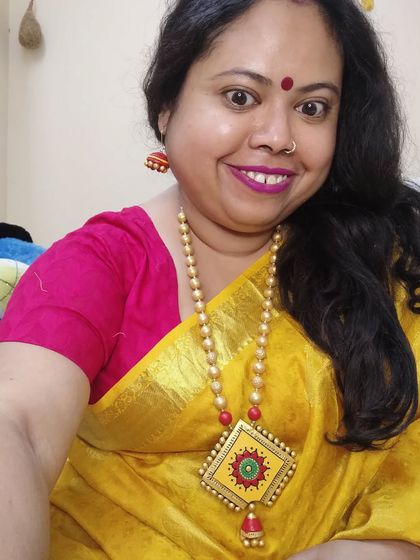 Here I am wearing my long yellow and red necklace. I love how the length and bright colors make it a perfect statement piece for a simple silk saree.