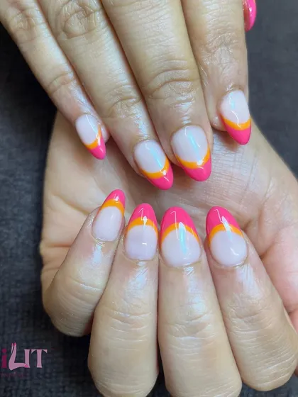 A before-and-after of a nail biter's transformation. We created these beautiful extensions with a modern, double-lined French tip in vibrant pink and orange.