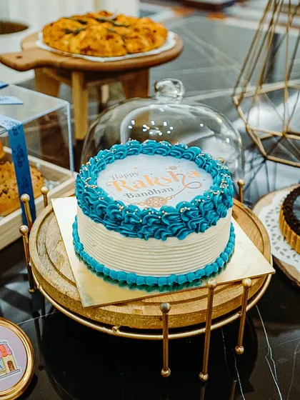 Make your celebrations interactive with my special 'burn away' cakes. This one was for Raksha Bandhan, where you can light the top layer to reveal a custom message or even a sibling picture underneath. It's a fun surprise that makes the moment unforgettable.