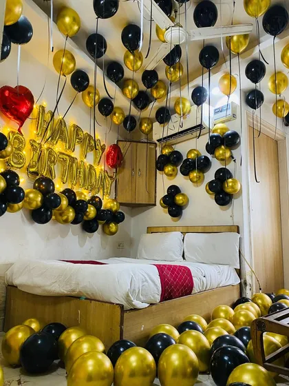 The warm glow from the light-up birthday banner adds a cozy and celebratory feel to this elegant room decoration.
