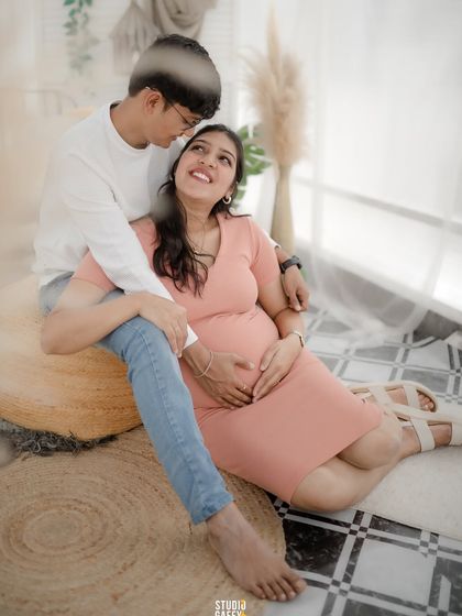 A soft and dreamy portrait capturing the loving gaze between an expectant couple.