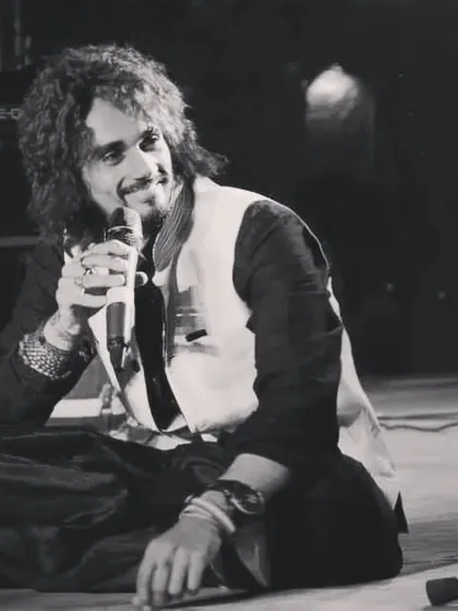 Sometimes the most powerful moments are the quietest. Here I am during a soulful, seated segment of a show, connecting with the audience through a classic melody before we turn up the energy.