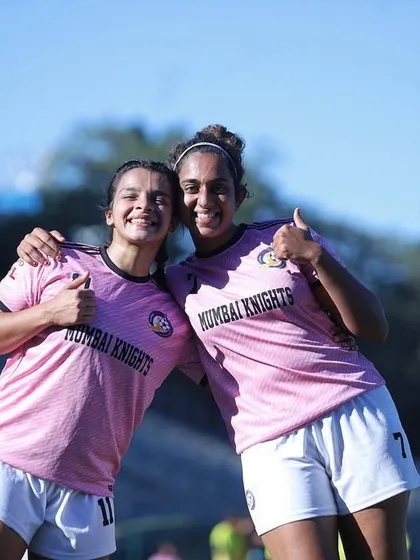 Two teammates sharing a hug and a thumbs-up after a successful match. The support we have for each other is everything.