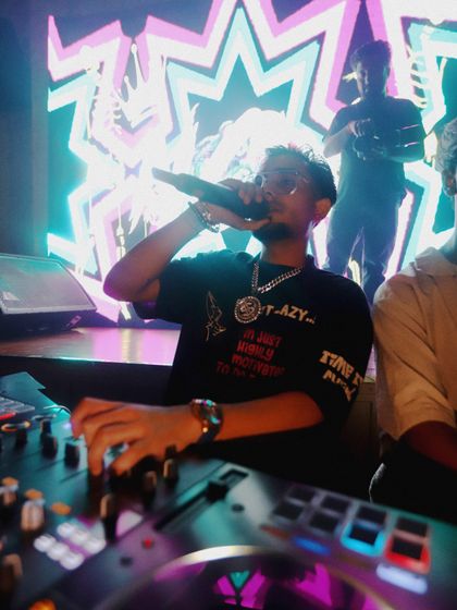 A shot of me on the mic while mixing. This dual role of DJ and MC is central to my service, allowing me to interact with the crowd and control the party's vibe.