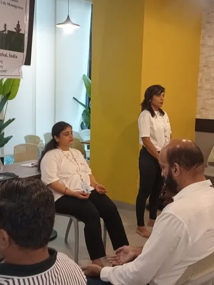 Our instructors guide a corporate group through a seated meditation. These sessions are tailored to the workplace, focusing on techniques that can be practiced at a desk to improve mental clarity and emotional balance.