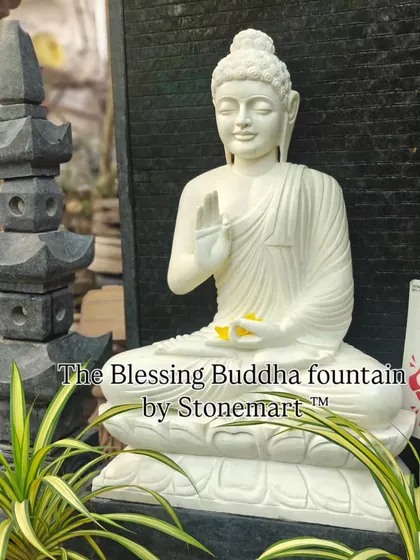 This close up shows the serene expression and intricate details of our 5-foot Blessing Buddha fountain. The statue is hand carved from a single block of pure white marble and sits before a granite waterfall, creating a tranquil centerpiece for any large home or garden.