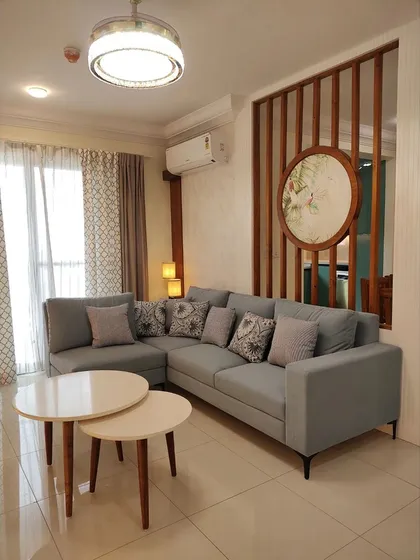 Your living room should be a haven of comfort and style. We designed this space with a plush L-shaped sofa, nesting coffee tables, and a unique slatted partition with custom art, creating an inviting atmosphere for family gatherings and quiet evenings.