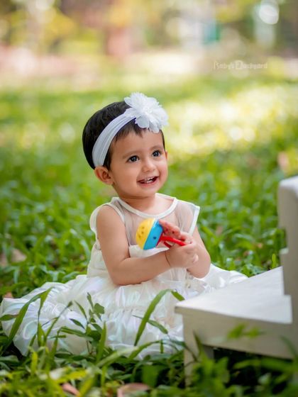 Smiles and snuggles with a favorite toy. Outdoor shoots are relaxed and fun for little ones.