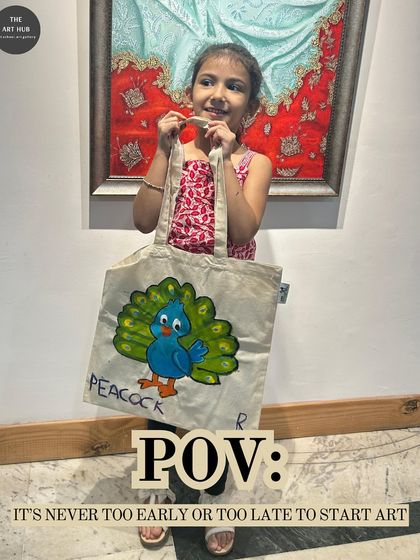 It is never too early to start art. This young girl is all smiles as she shows off the peacock she painted on a tote bag during one of my kids' workshops.
