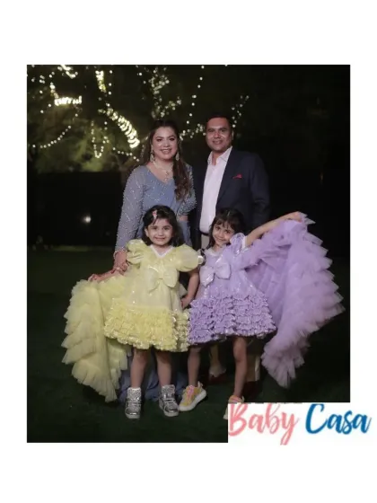 Sisterhood and celebration. We designed these beautiful yellow and lavender ruffled gowns for two sisters attending a family wedding, ensuring they both shined in their coordinated yet unique party dresses.