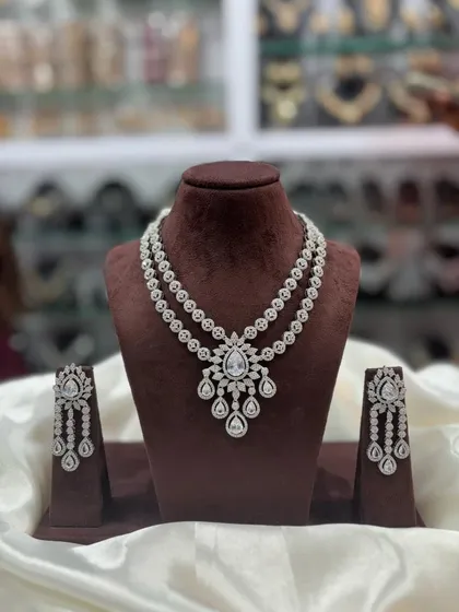 A double-layered AD necklace set with matching earrings, offering a sleek and modern look.