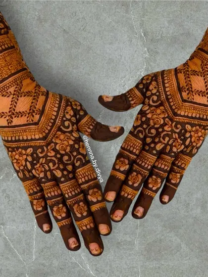 A full-coverage back-hand design with intricate floral and geometric patterns. The lotus border on the wrist completes this traditional look.