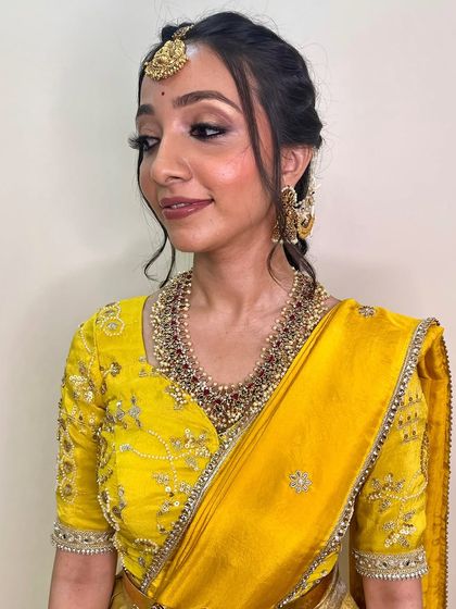 A side profile showing the delicate, braided hairstyle and the soft, blended eyeshadow. This look is a perfect example of simple, graceful beauty.