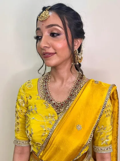 A side profile showing the delicate, braided hairstyle and the soft, blended eyeshadow. This look is a perfect example of simple, graceful beauty.