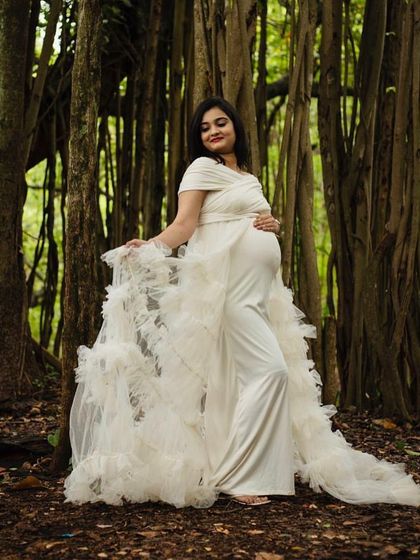 Another angle of the white ruffled gown, showing how it flows and moves. It's perfect for creating ethereal and timeless maternity portraits.