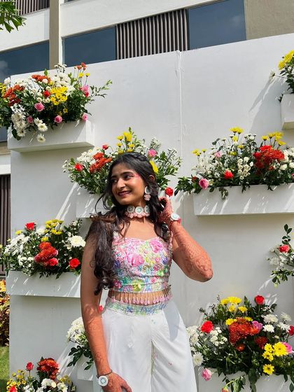 Me posing proudly in my hand-painted carnival outfit against a beautiful floral backdrop. The entire process, from design to the final stitch, was a labor of love.