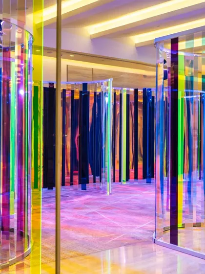 An entrance designed to mesmerize. We constructed this iridescent tunnel of light and reflection to create a modern, immersive journey for guests as they entered the sangeet, setting the stage for an unforgettable night.