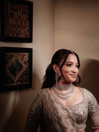 This is what pure joy looks like. For this reception look, I created a sparkling, glamorous style with a shimmering silver lehenga. The makeup was designed to be long-lasting and photo-ready, ensuring she looked flawless while dancing the night away.