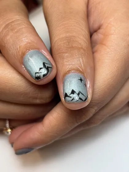 A close-up of the hand-painted mountain range from the Switzerland-themed nail set. Every detail is meticulously crafted to bring your vision to life on a tiny canvas.