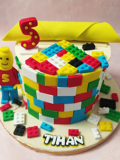 Build a great birthday with this Lego Blocks Cake, featuring a Lego man, colorful bricks, and a personalized name.