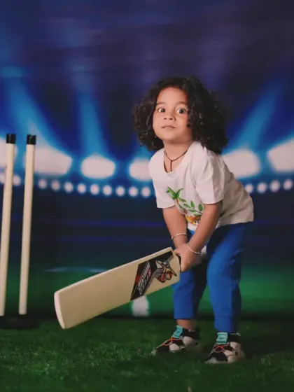 A future cricket star in the making. We can create sports-themed setups for your little champion, like this RCB-inspired cricket pitch.