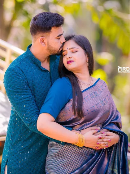 A tender and intimate portrait of a couple in traditional attire.