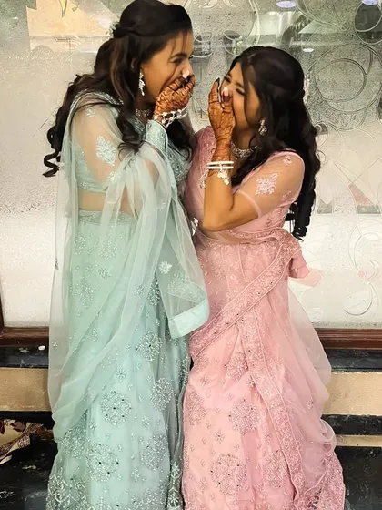 Another candid shot of sisters enjoying the celebration with their stunning mehendi.
