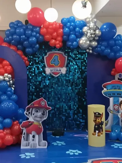 No job is too ruff for this Paw Patrol party setup. Featuring all the main characters as cutouts, a blue sequin backdrop, and a balloon arch in the classic red, blue, and silver colors.