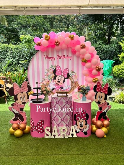 A slightly different angle of the outdoor Minnie Mouse setup, showing the beautiful garden venue.