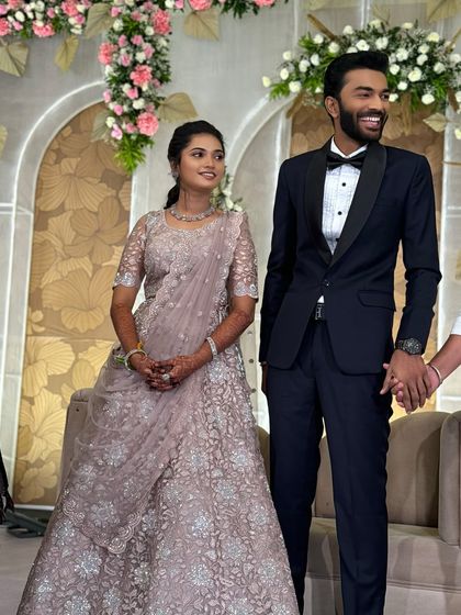 A candid moment between Ragavi and her groom. Her smile shows her happiness, and her glamorous yet understated makeup looks beautiful on stage.