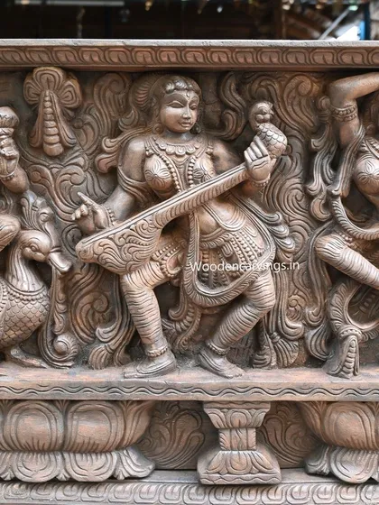 A view of another musician in the Apsara panel, playing a veena. The carving beautifully captures the interaction between the figure and her instrument.