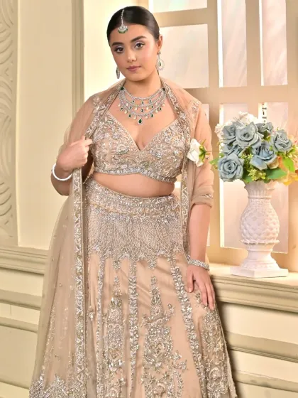 A confident pose from the bride, showing off her stunning diamond and emerald jewelry that perfectly complements the soft, dewy makeup.