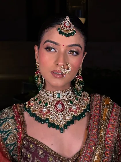 This is the moment we work for. A complete bridal look, where the jewellery, the outfit, and the bride's glow come together perfectly. This stunning Polki and emerald choker set is designed to make you feel nothing less than royal on your big day.