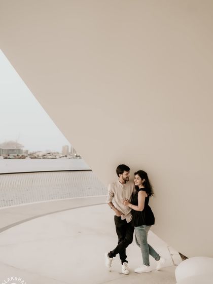 A quiet moment of connection, framed by the striking white architecture of a modern Dubai location.