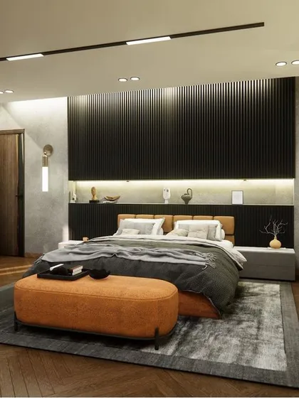This view of the modern contemporary bedroom in Noida showcases the bed and the custom headboard wall. The design uses a dark, moody palette with integrated backlighting and sleek wall sconces for a sophisticated, hotel-like feel.