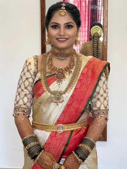 Mastering color theory is crucial. In my course, you will learn to work with a variety of bridal palettes, like this classic white and red Kanjeevaram look, ensuring the makeup harmonizes perfectly with the bride's attire.