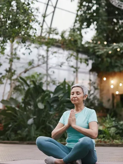 Our teacher training program is designed for everyone, regardless of age or current fitness level. Here, an experienced practitioner finds her balance, showcasing the journey of continuous learning and self-improvement that yoga offers.
