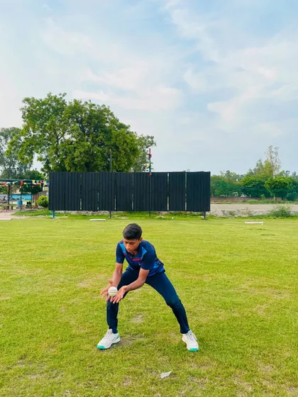 A young fielder focused and ready, demonstrating the "ready" position we instill in all our players before the ball is delivered.