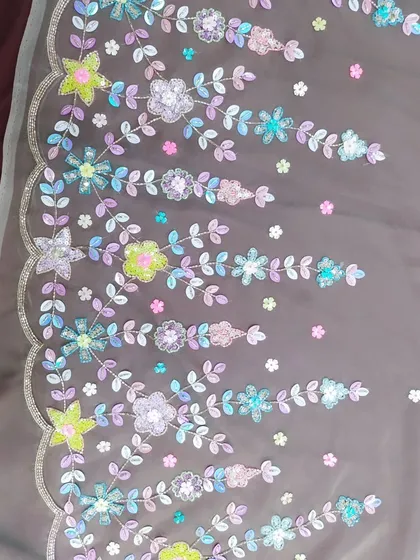 This is a close-up of the detailed handwork I love to create. Instead of traditional gold or silver, I used a palette of colorful sequins and beads to craft this floral pattern, adding a unique and modern touch to the final garment.