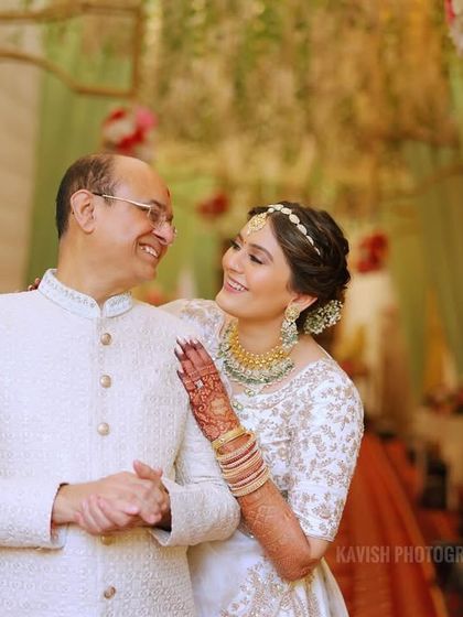 A sweet father-daughter moment, capturing the special bond they share on her wedding day.