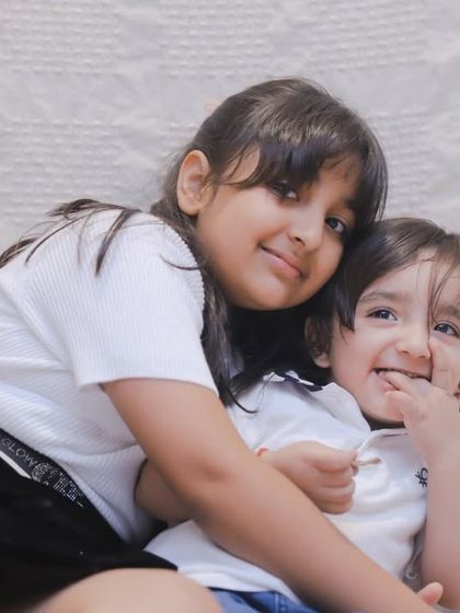 A sweet hug between siblings. We create a relaxed environment where kids can be affectionate and playful, resulting in authentic, heartwarming photos.