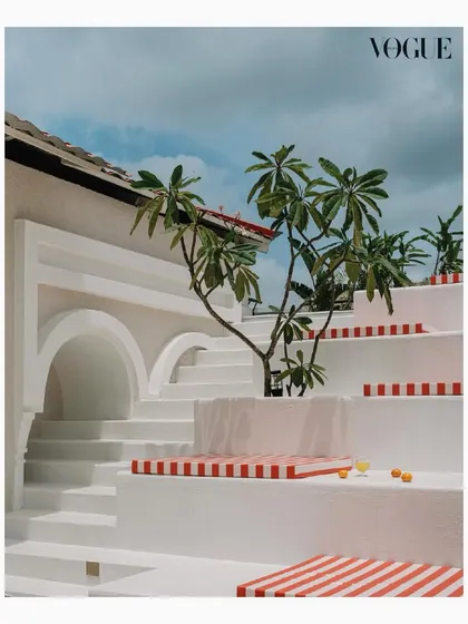 The terrace at Eden House feels like a postcard from the Amalfi Coast, right in the heart of Bangalore. We designed this space to be a true escape, with stepped seating, vibrant striped cushions, and a beautiful swimming pool, creating a lively haven for joy and relaxation.