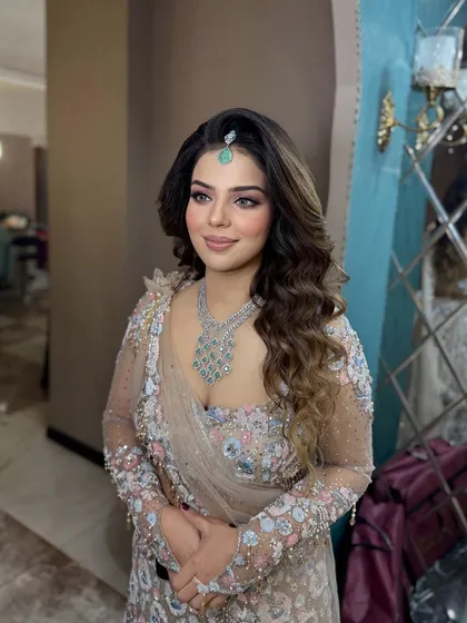 A soft glam makeup look that's all about the glow. The skin is luminous, the eyes are softly defined, and the hair is styled in beautiful waves.